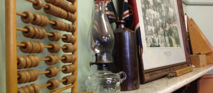 Displayed on the mantlepiece in the 1910 room is an abacus, oil lamp and a large ceramic ink bottle 