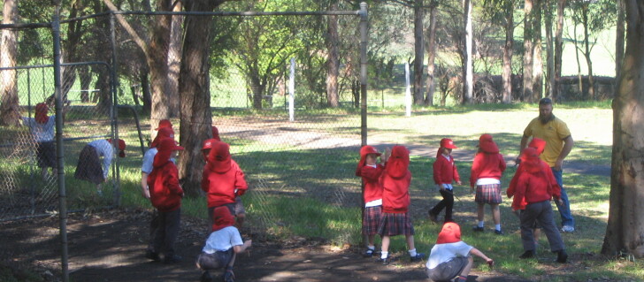 Visiting students can play in designated areas of the North Ryde school's grassy playground under supervision of their class teachers