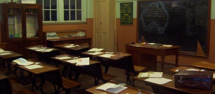 1910 room with school books open on desks.
